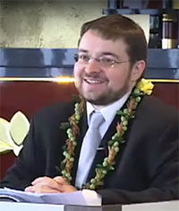 Dr. Jeff Wilson with lei at Hawaii Betsuin in 2011 delivering Futaba Memorial Lecture (video still from video by Wade Toyama)