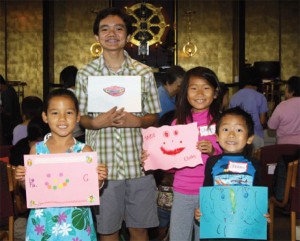 Dharma School children holding smile art