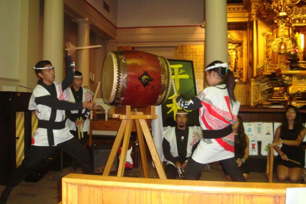 the Pacific Buddhist Academy taiko group performs in the hondo at the Peace Day Interfaith Celebration