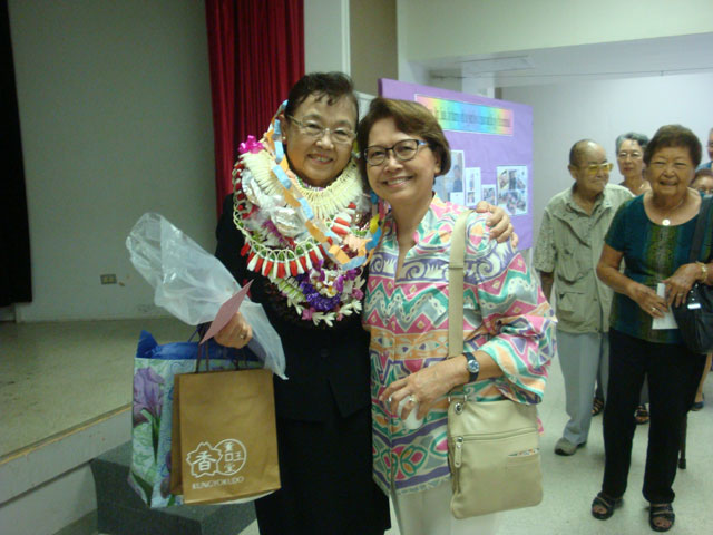 Mrs. Saito poses with a friend