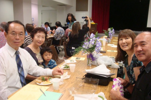 a table with event attendees, including Rev. and Mrs. Muneto