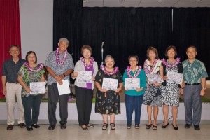 Seven Asoka Award winners holding their certificates with Arthur Nakagawa and Rimban Muneto on either side.
