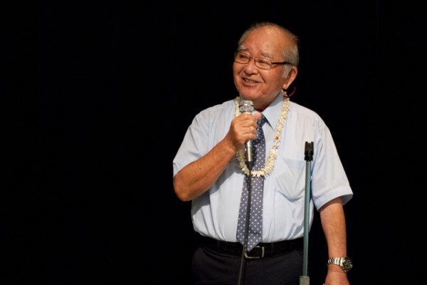 Rev. Toshima sings on the stage in the social hall