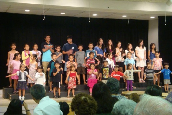 many children singing on stage