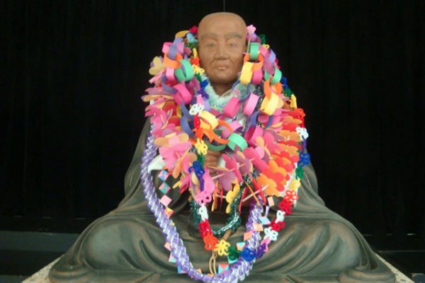 Shinran Shonin cedar statue with leis