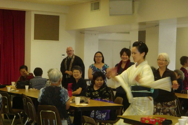 dancer from Japan leads sangha members in a Bon Dance in the social hall