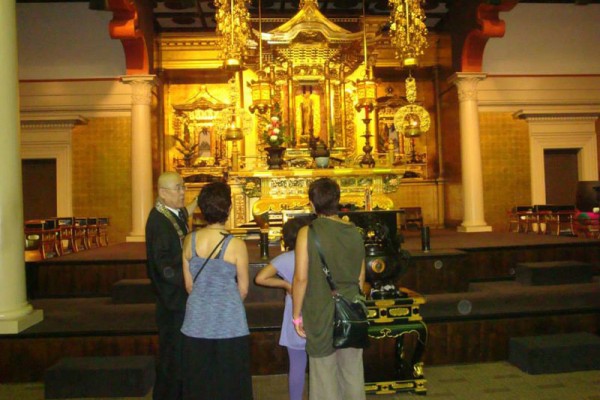 Visitors view the altar in the main temple hall