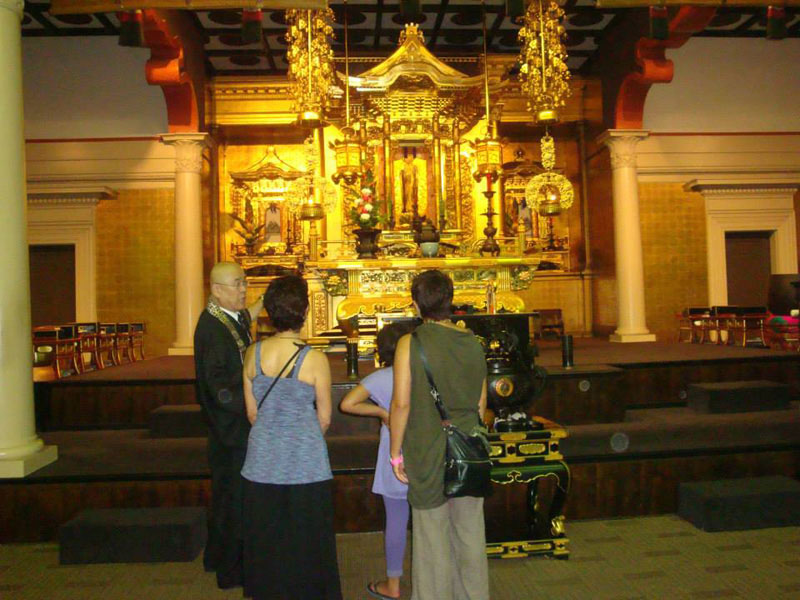 Visitors view the altar in the hondo