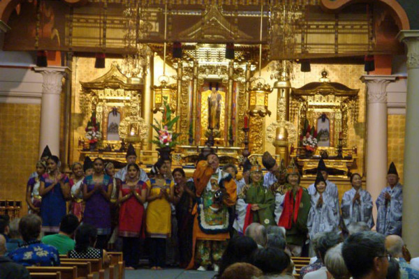 performers at the front of the hondo preparing to bow