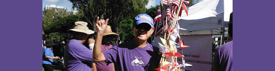 Norman Hirohata-Goto with origami cranes and American flags