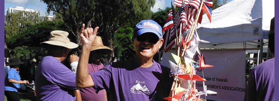 Norman Hirohata-Goto with origami cranes and American flags