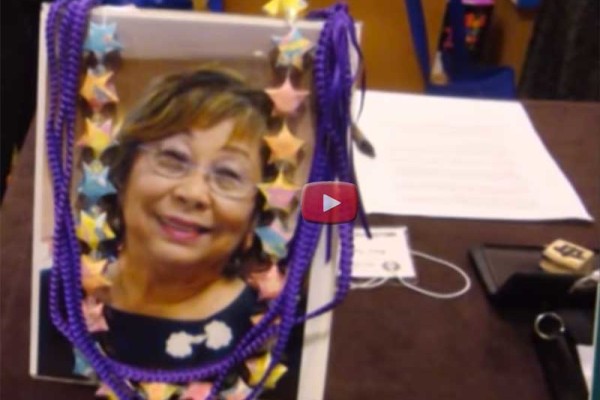 Photo of Lois Yasui, adorned with lei, in the video of "Passing On the Legacy of the Kimono"