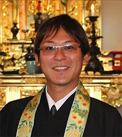 Rev. Shawn Yagi in front of the altar