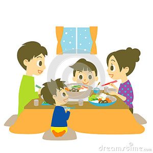 Family eating Japanese hot pot dish.