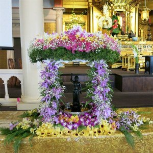 floral altar with baby Shakyamuni Buddha