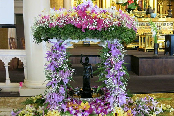 floral altar with baby Shakyamuni Buddha