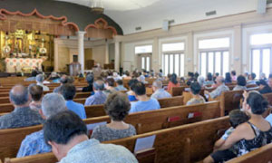 attendees in pews in the main temple hall for a combined Bon Mairi service