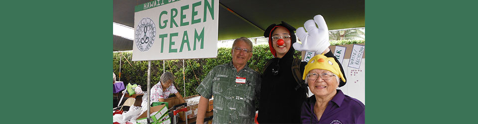 Green Team sign with team members, including Rev. Tomioka with Disney-esque costume