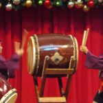 Debbie and Alan Kubota play a large taiko drum