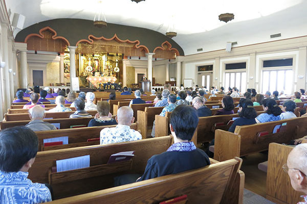 looking toward the altar over pews with attendees