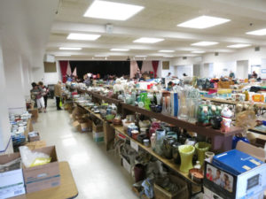 tables in the social hall loaded with Bazaar rummage sale items