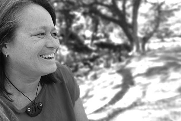 black and white photo of Manulani Aluli Meyer smiling outdoors