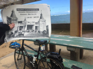 century ride - Betsuin Centennial sign by bike with ocean background