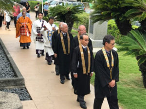 Hawaii Betsuin Board President Dexter Mar followed by four past Chief Ministers (in black), and Hawaii Betsuin ministers (in white), Bishop Matsumoto, and Rimban Hagio.