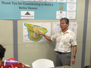 Kahauiki Village tour - Duane gestures toward a site plan drawing