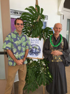 Michael Kieran (with lei) and David Atcheson next to bamboo "tree" decorated with greenery