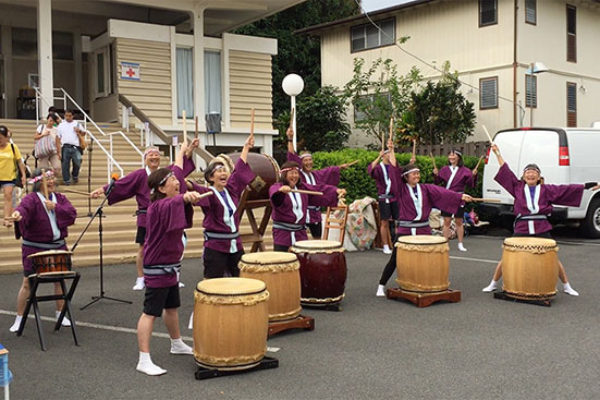 Betsuin taiko group with arms upraised, mid performance, at Taste of Hongwanji 2019