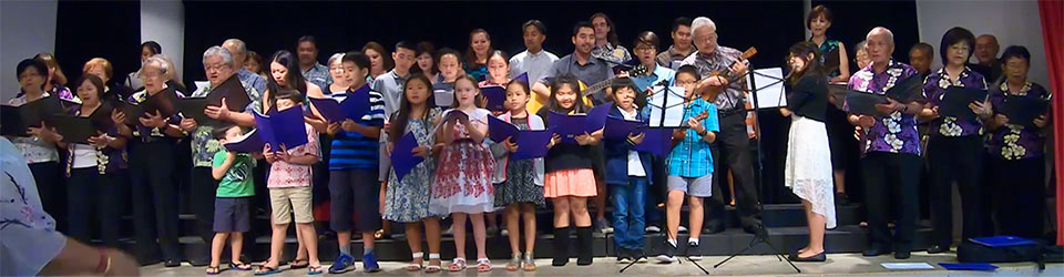 combined Betsuin Choir and Dharma School Ohana on stage singing