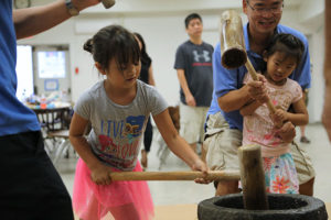 Mochitsuki, July 2019 - girl pounds rice with a mallet