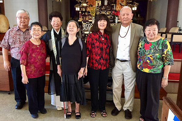 a few members of the choir are with emcee Rev. Irene Matsumoto and the event's keynote speaker, Professor Emeritus Roy Tamashiro, at Dharmachakra Festival 2019