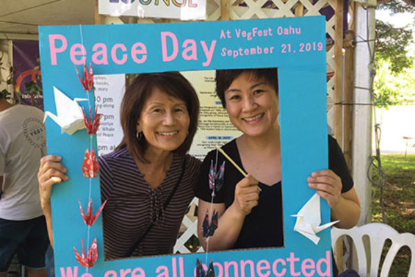 Dianne and Rev. Hasebe in the Peace Day photo frame for social media posting