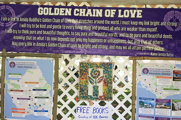 Inside the Peace Day Lounge at VegFest Oahu 2019 - Golden Chain banner, posters, free books
