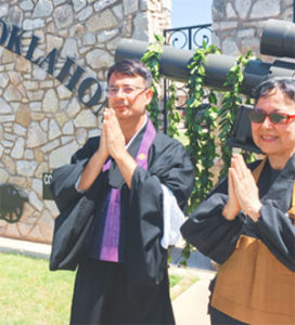 Rev. Dr. Duncan Williams in robes with hands together outdoors