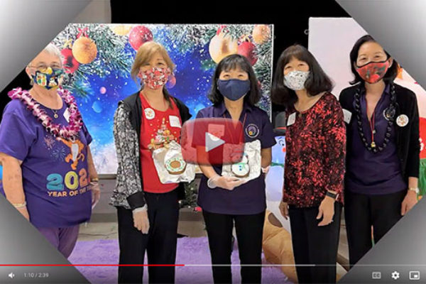 BWA year-end party video - 5 women in front of holiday backdrop, two displaying cookies