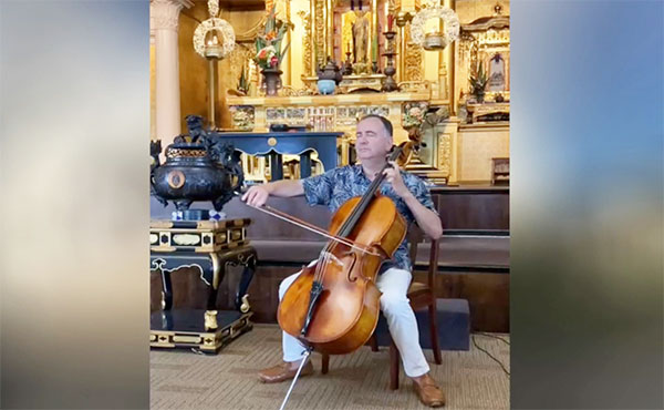 video frame of Udi Bar-David playing cello in the Hawaii Betsuin hondo