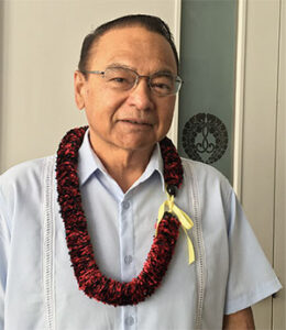Kahu Sherman Thompson wearing lei outside Hawaii Betsuin's Hondo