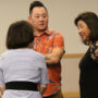 Debbie Kubota  (organizer from Honpa Hongwanji) talks with panelists Aiden Aizumi and Marsha Aizumi before the event (Kagirinaki Ai to Jihi, 10/25/24)