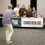 Taking a photo of folks the PFLAG O‘ahu table (Kagirinaki Ai to Jihi, 10/25/24)