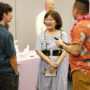 Panelists Marsha Aizumi and Aiden Aizumi (wearing lei) chat with attendees before the event (Kagirinaki Ai to Jihi, 10/25/24)