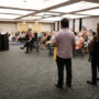 Jon Matsuoka (Hawai‘i Betsuin) and Debbie Kubota (Honpa Hongwanji Office of Buddhist Education and Hawai‘i Betsuin) with lei ready to present to panelists (Kagirinaki Ai to Jihi, 10/25/24)