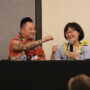 Aiden Aizumi hands a tissue to his mom, Marsha, during an emotional part of her remarks (Kagirinaki Ai to Jihi, 10/25/24)