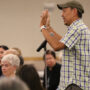 An attendee makes a comment at the mic (Kagirinaki Ai to Jihi, 10/25/24)