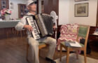 YouTube screen capture of Dr. Steve Chen playing Hawai‘i Aloha on accordion (2025 New Year’s Party)