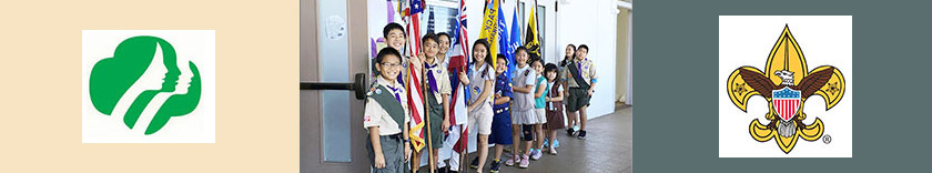 Scouts with flags outside hondo and scout logos