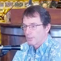 David Atcheson at emcee podium