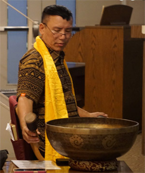 Lama Wangchuk strikes a singing bowl in the Annex Temple